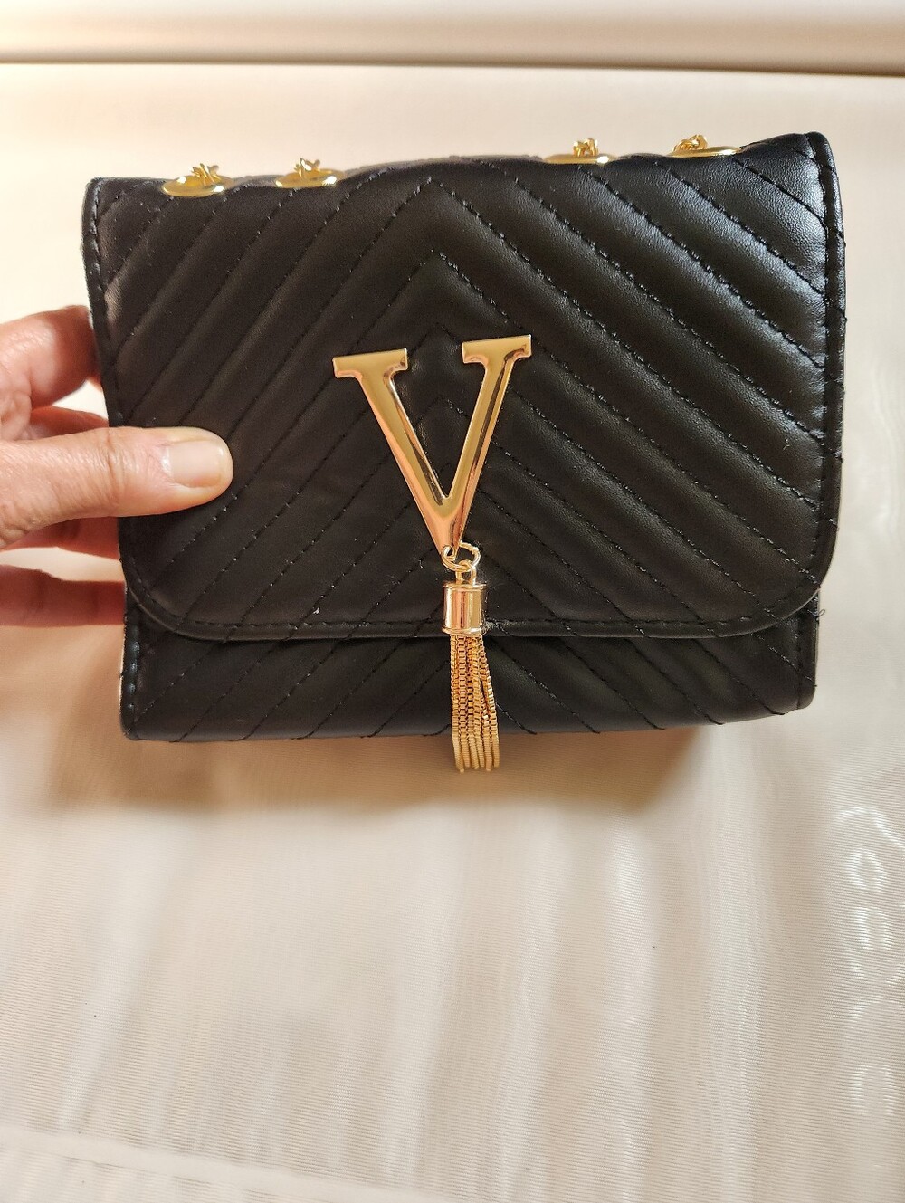 Black Quilted Crossbody Bag with Gold V Tassel
